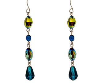 Long dramatic teal blue and green glass earrings created with teardrop, tube, and round shape glass beads. 2.17" long