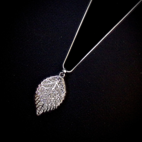 Sparkling leaf pendant necklace designed with all crystals inside a large polished silver leaf pendant. Fashion leaf necklace.