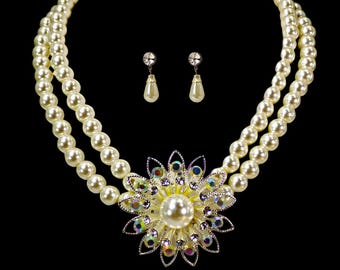 Large flower pendant pearl necklace and earrings designed with a double row of white glass pearls and aurora borealis sparkling crystals