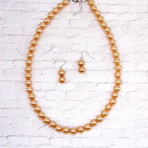 Beige pearl bead necklace and earring set designed with all 10mm round beige polished acrylic pearl beads. Elegant pearl jewelry set.