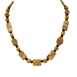 Brown and beige agate stone and wood bead necklace designed with a mix of beige stone shapes and small brown wood spacer beads.
