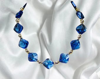 Blue glass necklace with silver beads designed with light blue square glass beads, and shiny silver round beads.