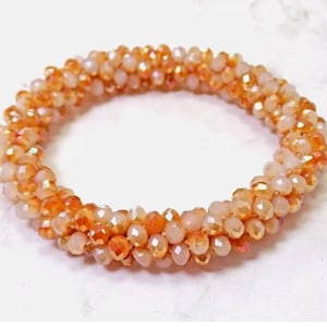Orange and white all glass beaded cluster stretch bracelet with all facet cut glass beads. Multi color beaded bracelet.