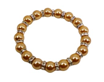 Pretty beige pearl and crystal bead stretch bracelet designed with 10mm polished round pearl beads separated by clear crystal spacer beads.