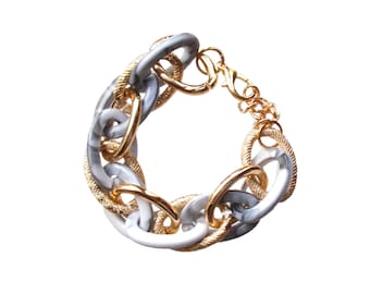 White and gold link bracelet designed with shiny white acrylic links and gold plated links with a textured and shiny finish.  7.5 inches