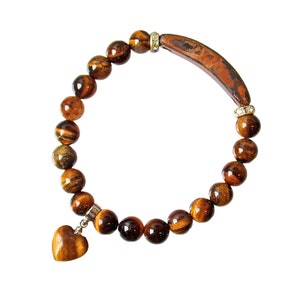 Tigers eye heart charm bracelet made in all brown stone beads and crystal spacer beads.  Stretch bracelet with heart charm and curved stone.