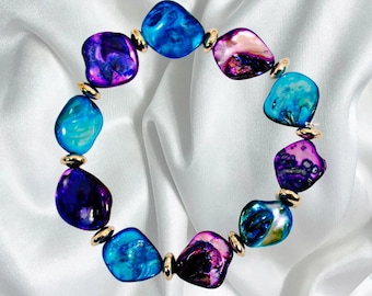 Purple and blue shell stretch bracelet with silver spacer beads. Colorful fashion bracelet.