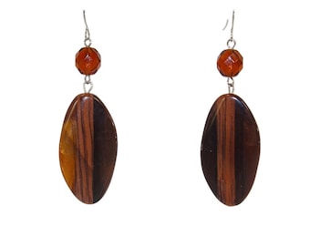 Brown earrings designed with a large oval faux wood bead and brown glass bead. 2.30" long.