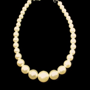 White pearl statement necklace created with large round faux pearl beads that graduate in size.
