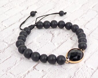 Black stone beaded bracelet with black glass bead and adjustable size slide tie back