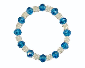Aqua blue glass beaded stretch bracelet created with aqua blue color glass beads and white acrylic disk beads.