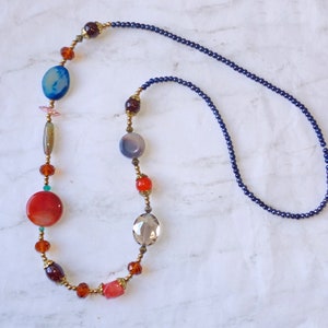 Colorful multi color glass beaded necklace, created with various shapes in a beautful color mix of orange, blue, purple, brown, and gray