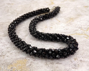 Elegant black all glass bead necklace made in a cluster beaded rope design with all sparkling glass beads.