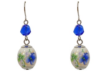 Pretty blue flower porcelain beaded earrings with blue flower design all around the beads, and blue glass beads.