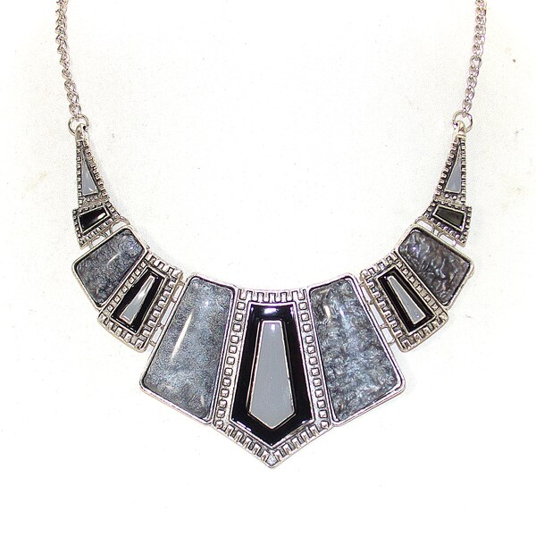 Black and gray statement necklace designed with gray cabochon bead sections and black and gray enamel sections linked together.