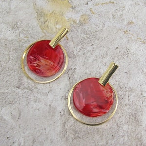 Red and gold disk hoop earrings in a marble acrylic look finish and post back.
