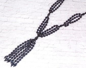 Long black tassel necklace designed with polished black glass pearls mixed with black glass beads and seed beads