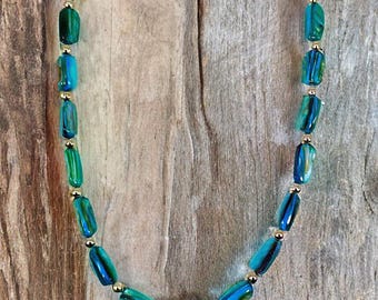 Blue shell bead necklace made with long shell beads mixed with silver round beads.