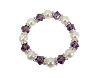 Purple glass and white faux pearl beaded stretch bracelet created with facet cut deep purple color glass beads and crystal spacer beads.,