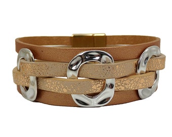 Beige leather cord wrap bracelet with hammered finish silver rings and gold end caps.  Wide bracelet with four rows of cord.