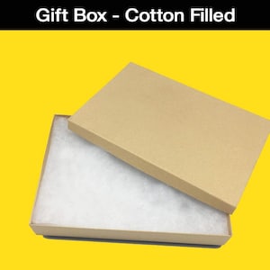 May include: A brown cardboard gift box with a white cotton filling. The box is open and the lid is resting on top of the box. The text "Gift Box - Cotton Filled" is printed on the top of the image. The text "Fits Slabcase or Standard Trading Card" is printed at the bottom of the image. The text "*Slabcase and cards sold separately.*" is printed below the text "Fits Slabcase or Standard Trading Card".