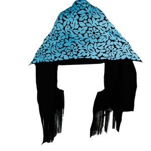 May include: A black hooded scarf with a blue floral pattern. The scarf has fringe on the ends.