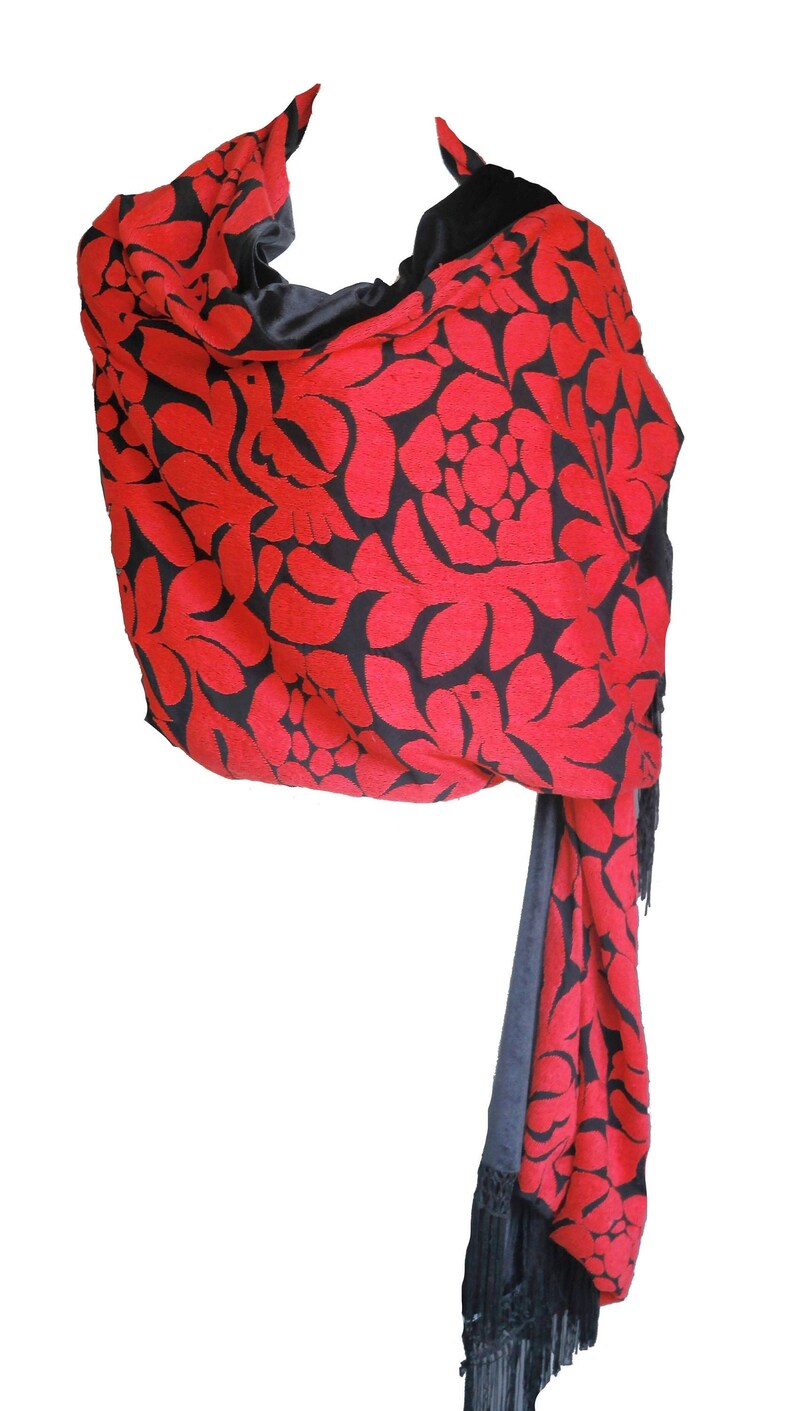 May include: A red and black shawl with a floral pattern and fringe. The shawl is made of a soft, luxurious fabric and is perfect for adding a touch of elegance to any outfit.