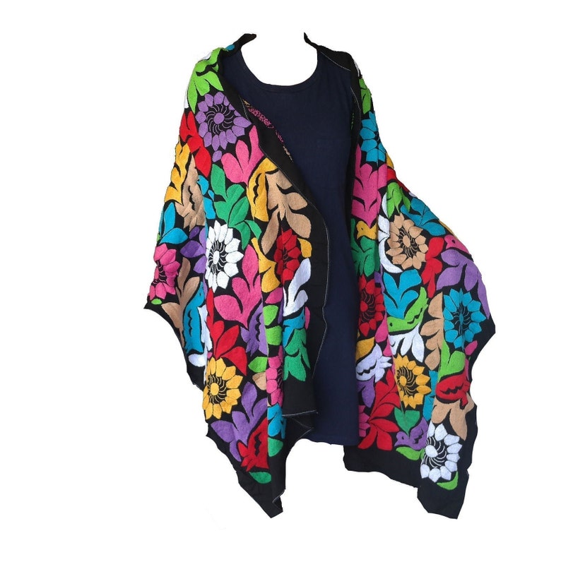 May include: A black shawl with colorful embroidered flowers. The shawl is made of a soft, lightweight fabric and is perfect for adding a touch of color to any outfit.
