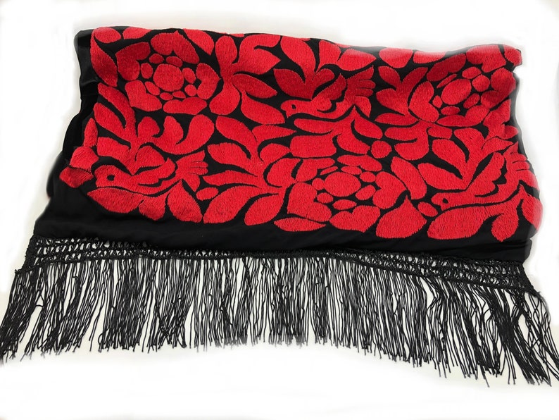 May include: Black shawl with red embroidered floral pattern and black fringe.
