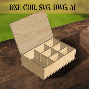 May include: Open wooden box with a lid and multiple compartments. The box is made of light brown wood and has a natural wood grain finish. The box is sitting on a wooden surface.