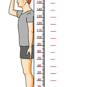 a man measuring his height with a ruler