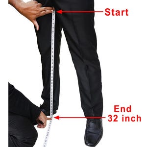 a man measuring his pants with a measuring tape