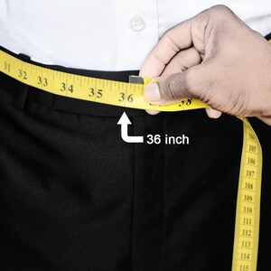 a man measuring his waist with a tape