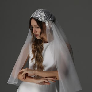 Bride wearing juliet cap wedding veil two tier with blusher