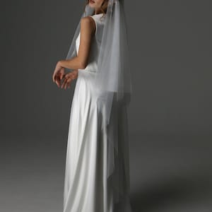 Bride wearing juliet cap wedding veil two tier with blusher