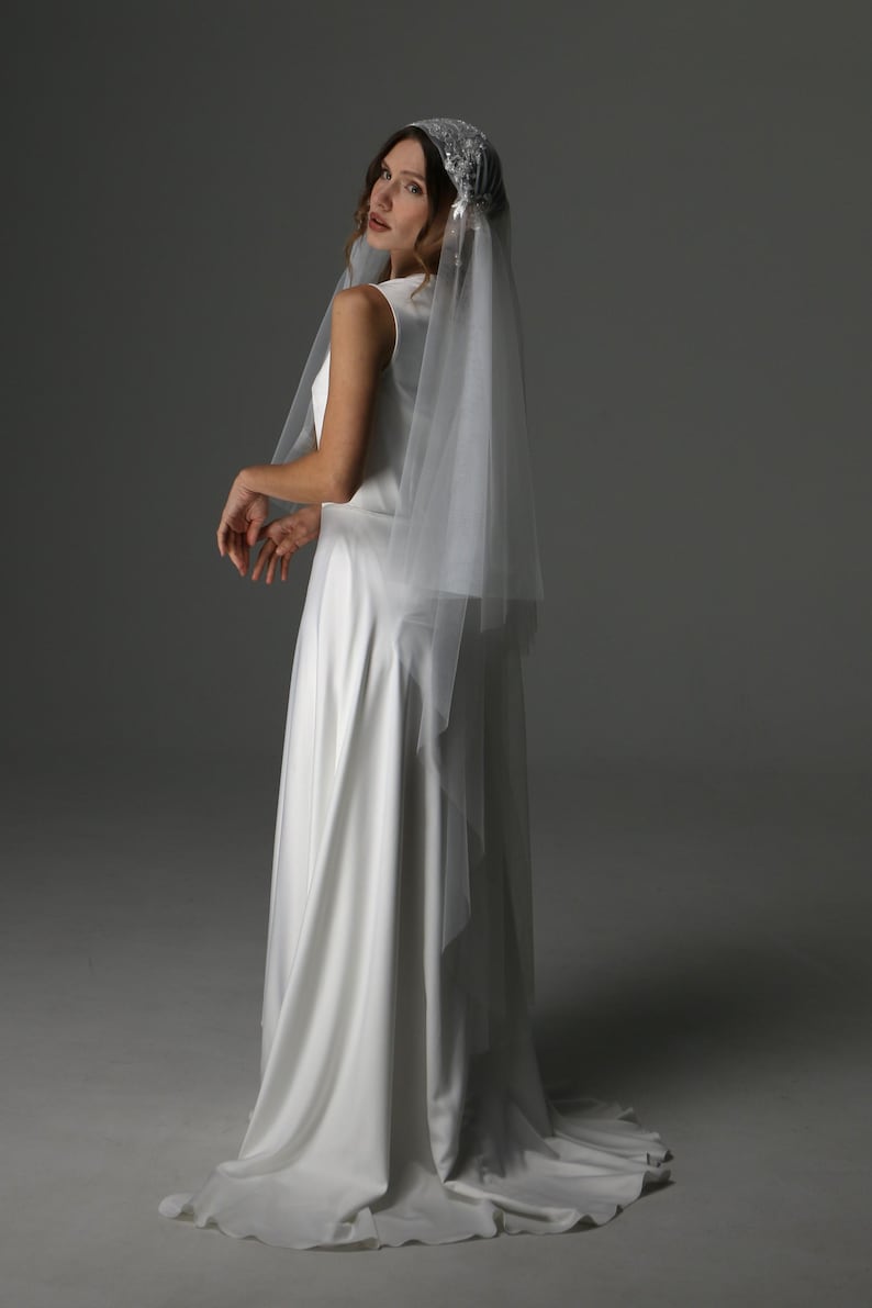 Bride wearing juliet cap wedding veil two tier with blusher