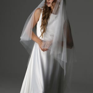 Waltz length two tier veil draping over shoulders