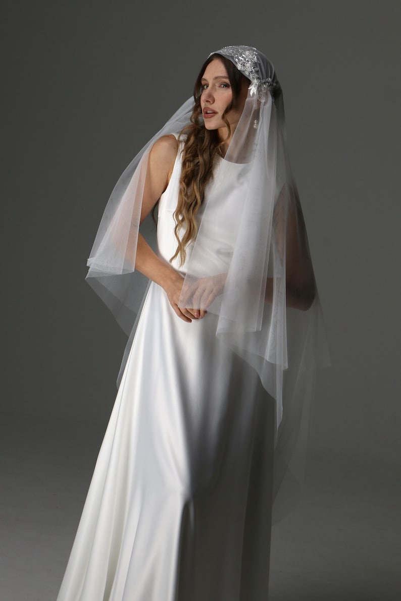Waltz length two tier veil draping over shoulders