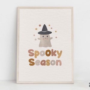 May include: A printable art print with a cute ghost wearing a witch hat and surrounded by stars. The text "Spooky Season" is written in a colorful, retro font.