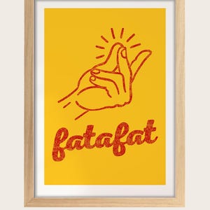 a hand gesture with the word "fatfat" written below it in a red font against a yellow background. The frame is made of oak wood.