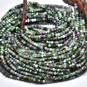 May include: A strand of green, pink, and white gemstone beads. The beads are faceted and have a rough, natural texture. The strand is approximately 16 inches long and is perfect for making jewelry.