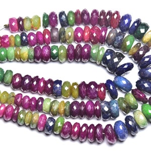 May include: A strand of faceted gemstone beads in shades of green, blue, and pink. The beads are strung on a thin wire and are ready to be used for jewelry making.