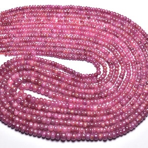 May include: A strand of pink ruby beads, approximately 4mm in size, arranged in a circular pattern. The beads are faceted and have a smooth, polished finish.