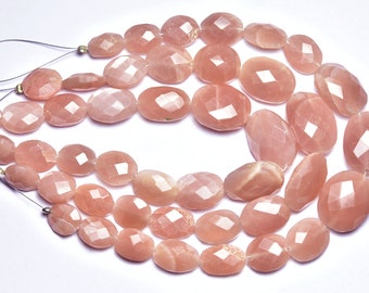 May include: A strand of peach-coloured sunstone beads, each bead is faceted and oval shaped. The beads are strung on a thin wire and are ready to be used for jewellery making.