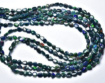 May include: A strand of dark green and black opal gemstone beads. The beads are irregularly shaped and have a smooth, polished finish.