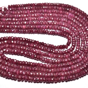 Puede incluir: Una hebra de cuentas de piedras preciosas facetadas de color rojo rubí. Las cuentas están enhebradas en un hilo fino y tienen aproximadamente 4 mm de diámetro.