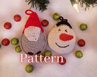 May include: Crocheted Christmas ornaments, a gray gnome with a red hat and a white snowman with a black hat and red nose. The ornaments are surrounded by red and green glitter balls.