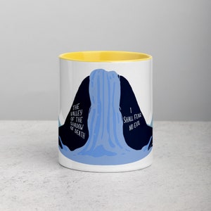 May include: White ceramic mug with a yellow rim. The mug features a blue and black illustration of a waterfall with the text "The Valley of the Shadow of Death" on the left side and "I Shall Fear No Evil" on the right side.
