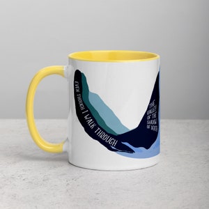 May include: White ceramic mug with a yellow rim and handle. The mug features a blue and green abstract design with the text "Even though I walk through the valley of the shadow of death".