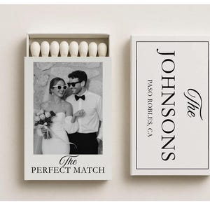 May include: A white matchbox featuring a black and white photograph of a couple in sunglasses. The text "The PERFECT MATCH" is below the photo. The matchbox cover has the text "The JOHNSONS PASO ROBLES, CA".